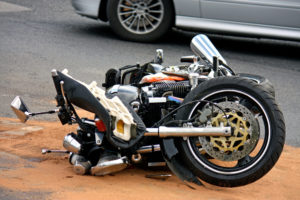 Wrecked motorcycle lying on the ground according to a Motorcycle Accident Lawyer Essex County, NJ