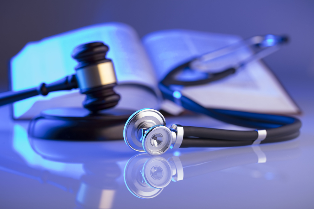How Lawyers Can Help Malpractice Victims - medical book, stethoscope, wood gavel