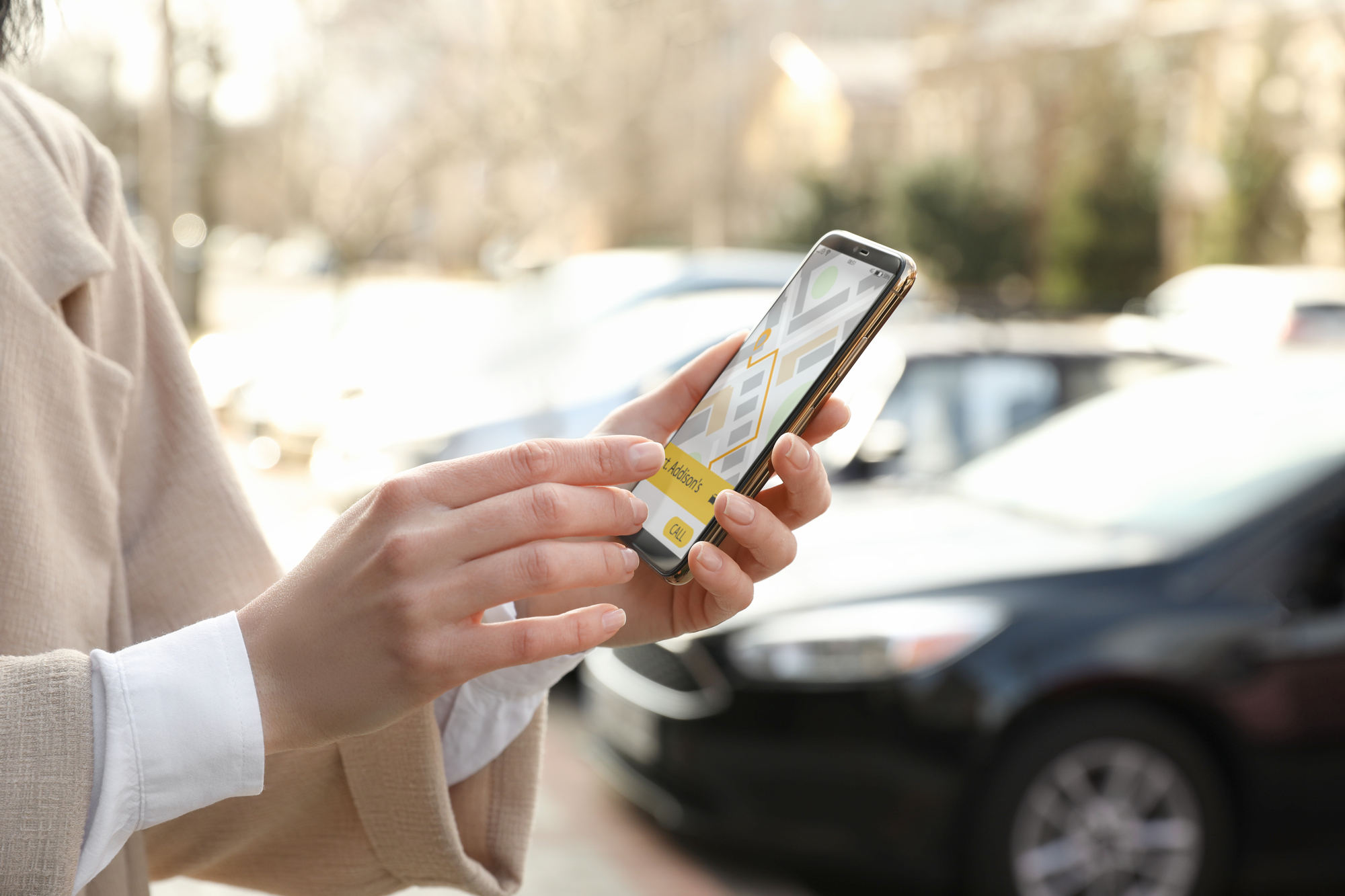 Why It’s Important To Consult An Uber Accident Lawyer - Woman ordering taxi with smartphone on city street, closeup